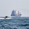 Tàu hàng neo ở ngoài khơi bán đảo Musandam, Oman, chờ qua eo biển Hormuz. (Ảnh: Getty Images/TTXVN)