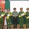 Đại tá Lâm Phước Nguyên, Giám đốc Công an tỉnh An Giang trao thưởng nóng Chủ tịch UBND tỉnh An Giang cho 4 tập thể. (Ảnh: TTXVN phát)