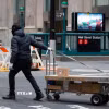 Nhân viên giao hàng làm việc tại New York, Mỹ. (Ảnh: THX/TTXVN)