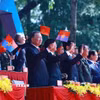 Tổng Bí thư Tô Lâm và các đại biểu theo dõi màn diễu binh, diễu hành từ trên lễ đài. (Ảnh: TTXVN)