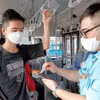 Hệ thống vé điện tử hiện đại được sử dụng trên xe buýt. (Ảnh minh họa: Vietnam+)