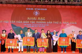 Các đại biểu tặng hoa và cờ cho 5 cộng đồng Mường đến từ Hà Nội, Sơn La, Phú Thọ, Lào Cai, Thanh Hoá tham gia Ngày hội. (Ảnh: Khánh Hoà/TTXVN)