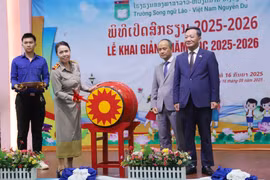 Hiệu trưởng Trường song ngữ Lào-Việt Nam Nguyễn Du Nguyễn Thị Thanh Hương đánh trống khai giảng năm học mới 2025-2026. (Ảnh: Xuân Tú/TTXVN)