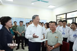 Tổng Bí thư Tô Lâm thăm hỏi nhân dân đến làm thủ tục hành chính tại Trung tâm hành chính công xã Phúc Thịnh. (Ảnh: Thống Nhất/TTXVN)