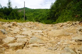 Mặt đường Trà Thanh-Trà Phong bong tróc nặng, lởm chởm đá, sỏi. (Ảnh: Lê Phước Ngọc/TTXVN)
