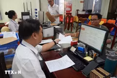 Giải quyết hồ sơ, thủ tục hành chính cho người dân và doanh nghiệp tại Trung tâm phục vụ hành chính công phường Rạch Giá (An Giang). (Ảnh: Lê Huy Hải/TTXVN)