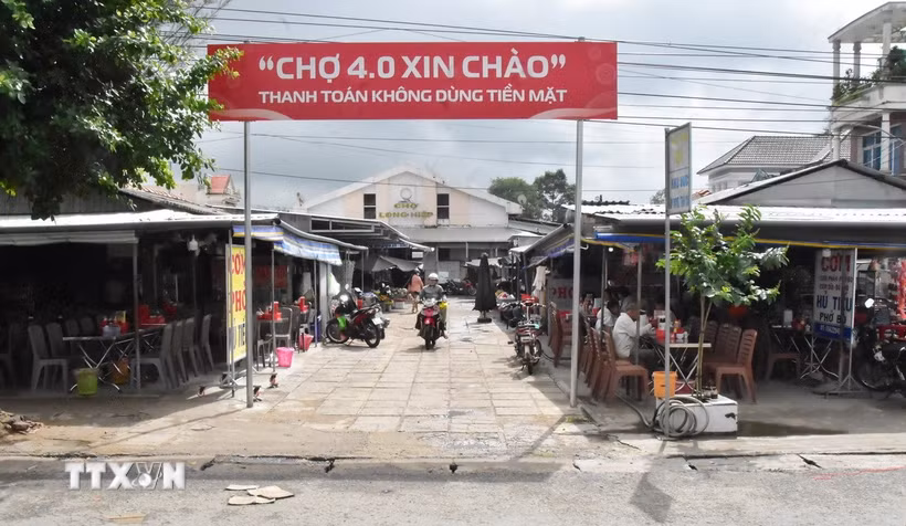 Chợ Long Hiệp triển khai mô hình “Chợ 4.0,” khuyến khích tiểu thương và người dân thanh toán không dùng tiền mặt. (Ảnh: Thanh Hòa/TTXVN)