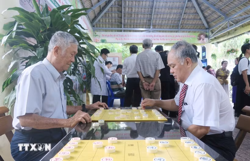 Người cao tuổi phường Bình Phú giao lưu đánh cờ tướng tại Nhà sinh hoạt cộng đồng. (Ảnh: Đinh Hằng/TTXVN)