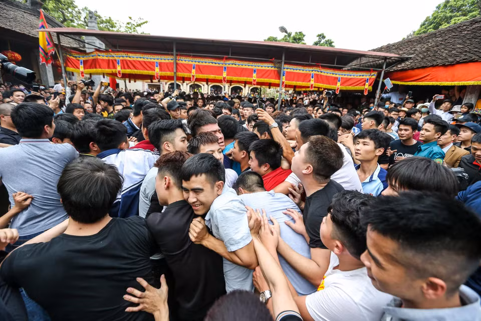 Tương truyền, người nào giành được cây bông cả năm sẽ gặp may mắn, riêng những ai đã có gia đình sẽ sinh được quý tử, do đó giằng bông là phần được trông đợi và diễn ra náo nhiệt nhất khi hàng trăm trai làng sẽ lao vào giành cây bông. (Ảnh: Minh Sơn/Vietnam+)