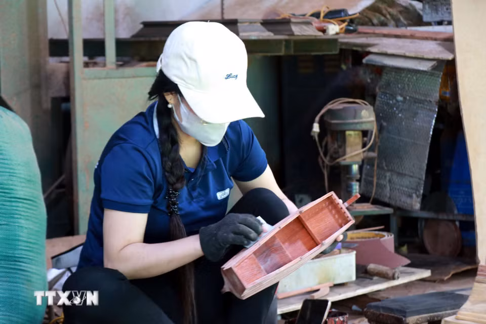 Công nhân mài nhẵn thân thuyền. (Ảnh: Nguyễn Lành/TTXVN)