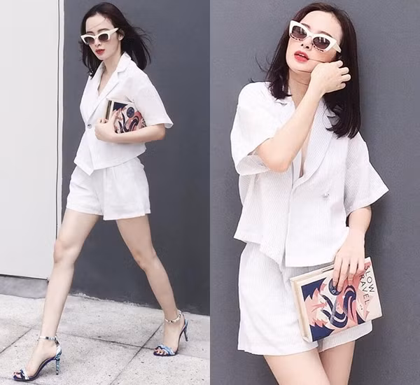 Trong khi các kiều nữ khác say đắm sắc đen và gam màu tối, Angela Phương Trinh lại chọn làm mới mình cùng trang phục tông màu sáng. Cô nàng mix đồ theo công thức tuyền trắng, với sơ mi kẻ tăm và quần shorts đồng điệu. Bên cạnh kính mắt mèo cùng sandals họa tiết, phụ kiện làm nên điểm nhấn cho bộ cánh chính là chiếc clutch hình quyển sách lạ mắt.
