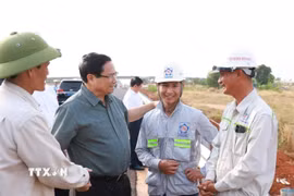 Thủ tướng Phạm Minh Chính với công nhân thi công dự án đường bộ cao tốc Biên Hòa-Vũng Tàu. (Ảnh: Dương Giang/TTXVN)