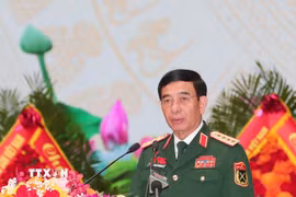 Đại tướng Phan Văn Giang, Ủy viên Bộ Chính trị, Phó Bí thư Quân ủy Trung ương, Bộ trưởng Bộ Quốc phòng trình bày Báo cáo chính trị. (Ảnh: Trọng Đức/TTXVN)