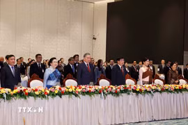 Tổng Bí thư Tô Lâm và Phu nhân, Tổng Bí thư Ban Chấp hành Trung ương Đảng Nhân dân Cách mạng Lào, Chủ tịch nước Cộng hòa Dân chủ Nhân dân Lào Thongloun Sisoulith và Phu nhân cùng các đại biểu thực hiện nghi lễ chào cờ. (Ảnh: Thống Nhất/TTXVN)