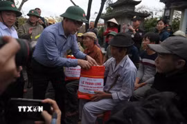Phó Thủ tướng Lê Thành Long thăm hỏi và tặng quà người dân thôn Luật Lễ, xã Tuy Phước, tỉnh Gia Lai. (Ảnh: Sỹ Thắng/TTXVN)