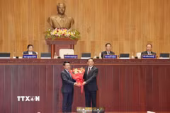 Chủ tịch Quốc hội Lào khóa X Sonexay Siphandone (phải) tặng hoa chúc mừng Thủ tướng Chính phủ Lào khóa X Saleumxay Kommasit. (Ảnh: Xuân Tú/TTXVN)