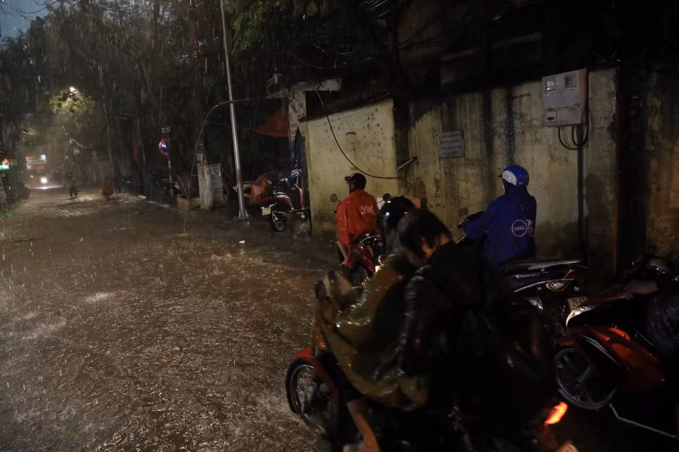 Phố Khương Hạ ngập khiến nhiều người đi lại khó khăn. (Ảnh: Tuấn Anh/TTXVN)