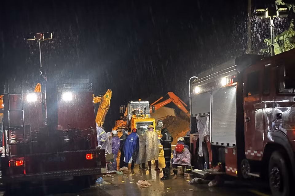 Mặc dù lực lượng chức năng khoảng 100 người, cùng nhiều phương tiện xe cơ giới, máy múc xuyên đêm thực hiện giải toả hiện trường nhưng do lượng đất đá quá lớn nên hiện mới chỉ dọn dẹp được một phần mặt đường để phục vụ công tác cứu hộ. (Ảnh: Nguyễn Dũng/TTXVN) 
