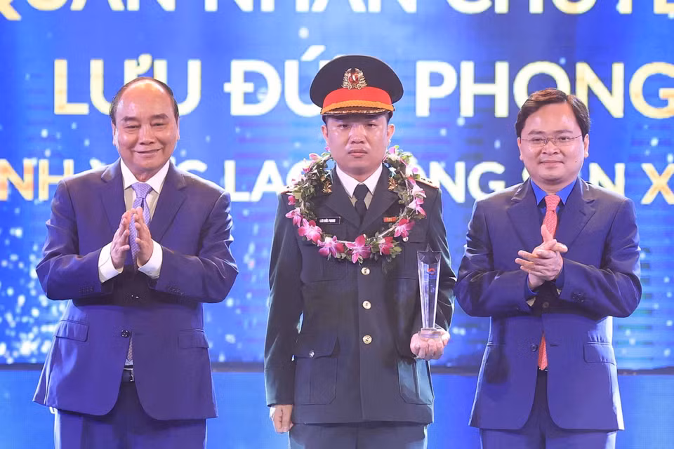 Chủ tịch nước Nguyễn Xuân Phúc và Bí thư thứ nhất Trung ương Đoàn Nguyễn Anh Tuấn trao biểu trưng tuyên dương các Gương mặt trẻ Việt Nam tiêu biểu năm 2021. (Ảnh: Thống Nhất/TTXVN)