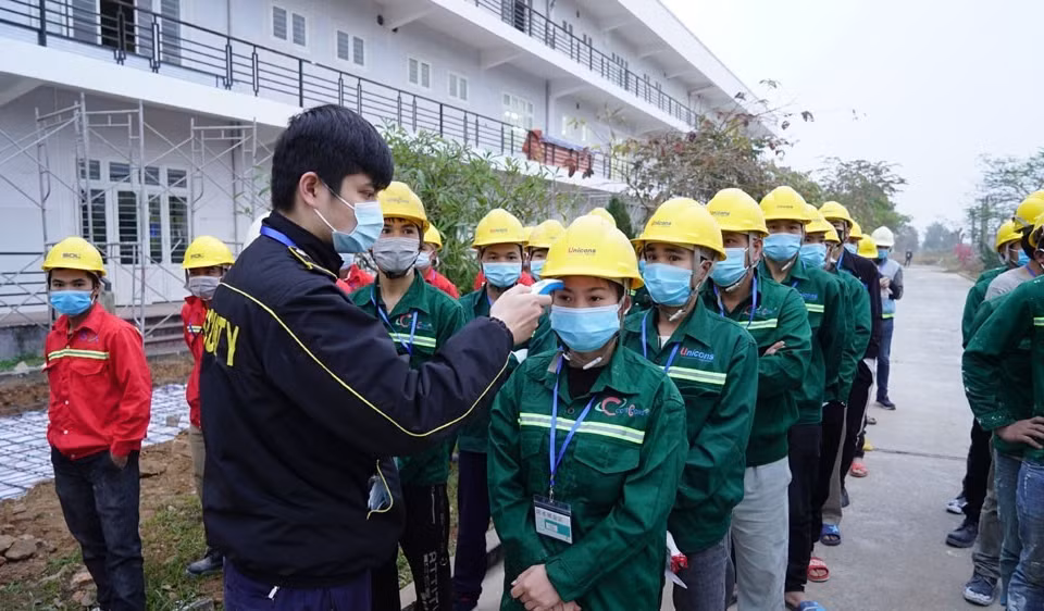 Công nhân, cán bộ thi công đều được kiểm tra thân nhiệt, xét nghiệm trước khi vào công trường và được yêu cầu tuân thủ nghiêm quy định phòng chống dịch. (Ảnh: TTXVN phát)