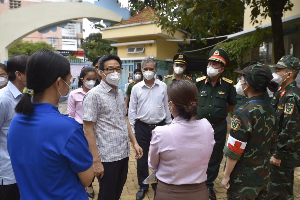 Phó Thủ tướng Vũ Đức Đam động viên lực lượng chức năng tham gia chống dịch trên địa bàn Quận 6.(Ảnh: TTXVN phát)