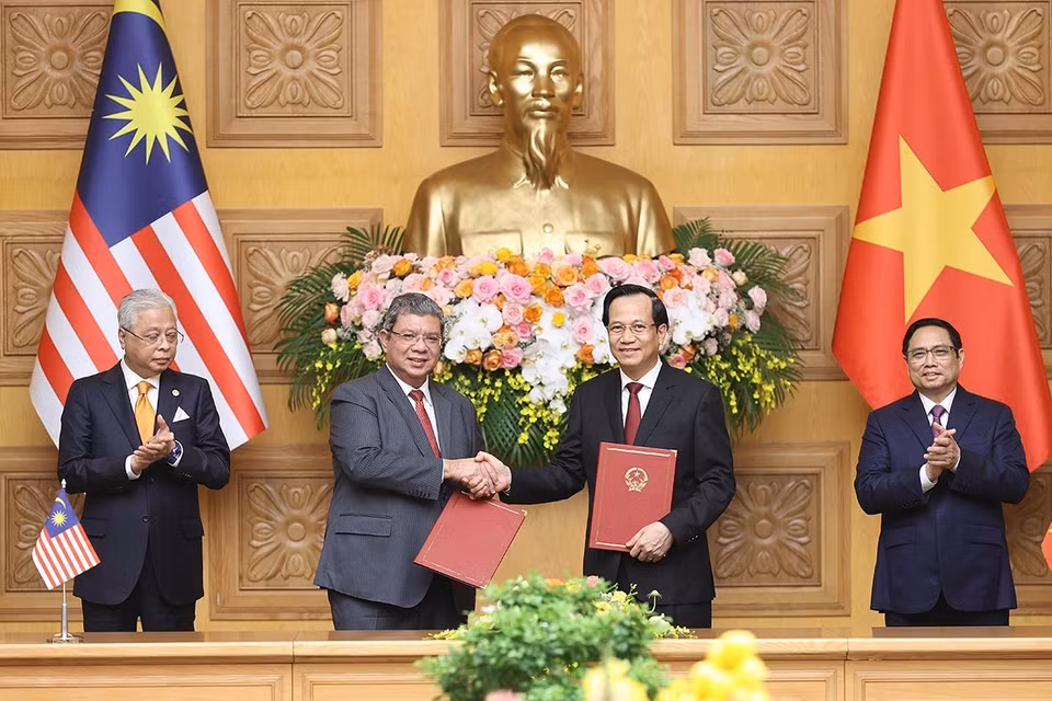 Bộ trưởng Bộ Lao động, Thương binh và Xã hội Đào Ngọc Dung và Bộ trưởng Ngoại giao Malaysia Dato' Sri Saifuddin bin Abdullah trao đổi Bản ghi nhớ giữa Chính phủ Việt Nam và Chính phủ Malaysia về tuyển dụng, việc làm và hồi hương lao động. (Ảnh: Dương Giang/TTXVN)