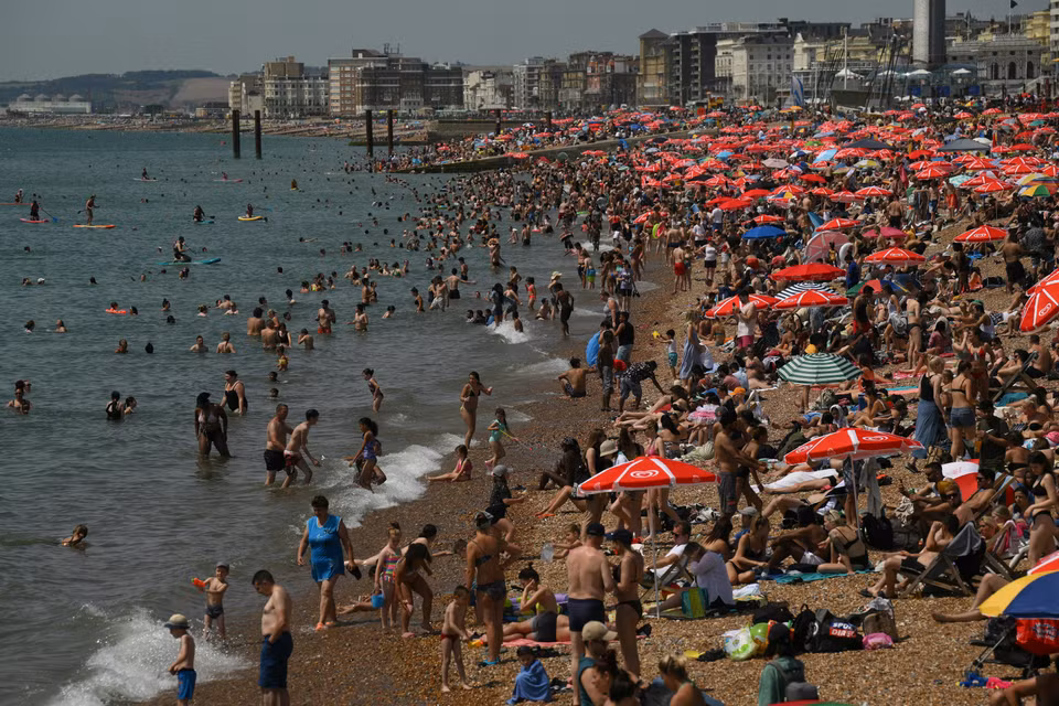 Bãi biển ở Brighton, miền Nam nước Anh, chật cứng du khách tránh nắng nóng khi nhiệt độ lên ngưỡng cao kỷ lục trên 40 độ C, ngày 17/7. (Nguồn: AFP/TTXVN)
