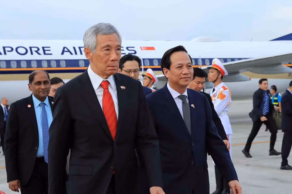 Bộ trưởng Bộ Lao động, Thương binh và Xã hội Đào Ngọc Dung và các đại biểu đón Thủ tướng nước Cộng hòa Singapore Lý Hiển Long tại Sân bay Quốc tế Nội Bài. (Ảnh: An Đăng/TTXVN) 