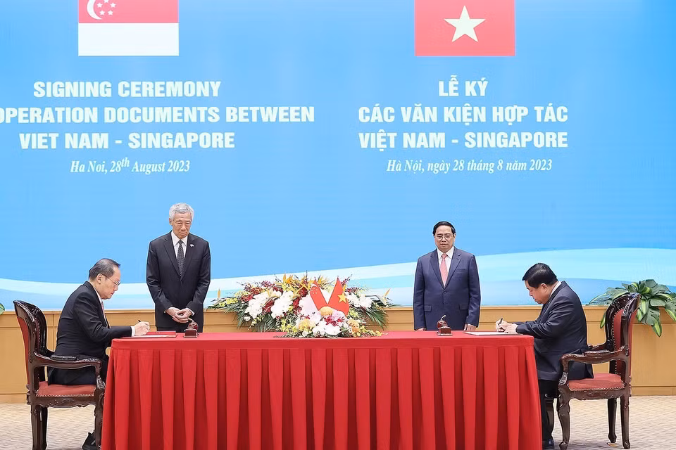 Thủ tướng Phạm Minh Chính và Thủ tướng Singapore Lý Hiển Long chứng kiến ký Công thư trao đổi về việc sửa đổi Hiệp định Khung Kết nối hai nền kinh tế Việt Nam-Singapore (năm 2005). (Ảnh: Dương Giang/TTXVN)