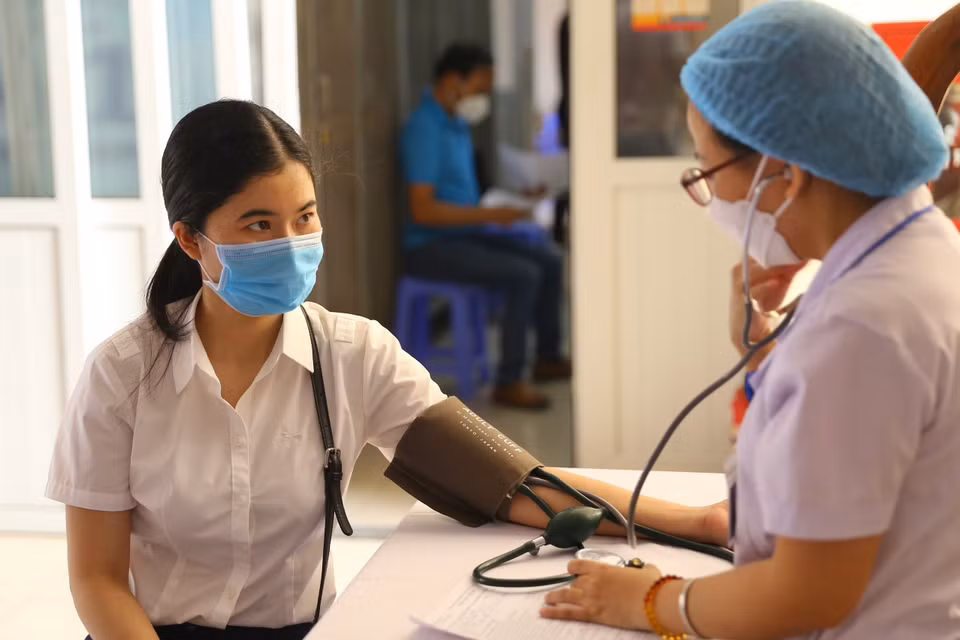 Khám sàng lọc trước tiêm cho người dân quận Hoàn Kiếm (chụp sáng 28/7 tại Trường tiểu học Nguyễn Du, Hàng Tre, Hoàn Kiếm). (Ảnh: Hoàng Hiếu/TTXVN)