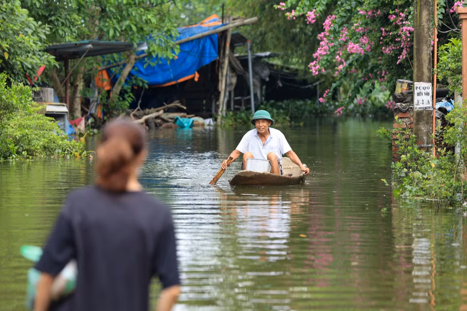 Người dân phải di chuyển bằng thuyền qua những nơi ngập sâu. (Ảnh: Hoài Nam/Vietnam+)