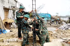 Lực lượng quân đội thực hiện xây nhà cho người dân vùng lũ ở Gia Lai. (Ảnh: Sỹ Thắng/TTXVN)
