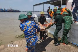 Cán bộ, chiến sỹ Hải đội Biên phòng 2, Bộ đội Biên phòng tỉnh Ninh Bình cứu hộ ngư dân gặp nạn trên biển. (Ảnh: TTXVN phát)