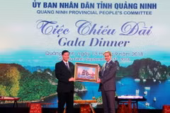 Chủ tịch Ủy ban Nhân dân tỉnh Quảng Ninh tặng ảnh lưu niệm cho đại diện lãnh đạo đoàn. (Ảnh: Văn Đức/TTXVN)