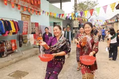 Những cô gái dân tộc Lào té nước cầu may. (Ảnh: Xuân Tư/TTXVN)