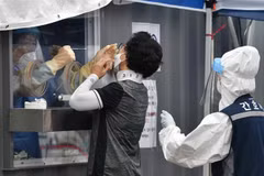 Nhân viên y tế lấy mẫu xét nghiệm COVID-19 cho người dân tại Seoul, Hàn Quốc ngày 26/8/2020. (Ảnh: AFP/TTXVN)