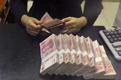 Kiểm tiền nhân dân tệ tại một ngân hàng của Trung Quốc. (Nguồn: Reuters)