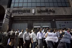 Viên chức Palestine xếp hàng yêu cầu được nhận lương bên ngoài Ngân hàng Palestine ở thành phố Gaza. (Nguồn: AFP/TTXVN) 