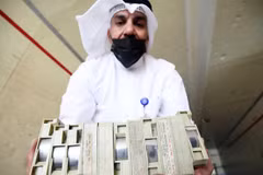 Nhân viên Bộ Thông tin Kuwait kiểm tra các hộp chứa tài liệu. (Nguồn: AFP)