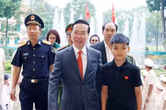 Chủ tịch nước Võ Văn Thưởng và em Lường Quốc Bảo, con của Đại úy, liệt sỹ Lường Phát Chiêm, Trung đội trưởng Phòng Cảnh sát bảo vệ và hỗ trợ tư pháp, Công an tỉnh Sơn La. (Ảnh: Thống Nhất/TTXVN)