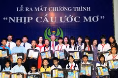Tặng quà cho các em học sinh nghèo học giỏi tiêu biểu năm học 2012-2013. (Ảnh: Hoàng Hải/Vietnam+) 