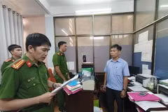 Công an tỉnh Quảng Ngãi đọc Quyết định khởi tố Bùi Mạnh Tường (sinh năm 1973), nhân viên Văn phòng đăng ký đất đai tỉnh Chi nhánh thành phố Quảng Ngãi. (Ảnh: TTXVN)