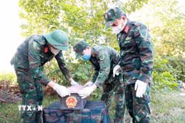 Hài cốt liệt sỹ được tìm thấy trên đỉnh núi Hòn Chảo (xã Vạn Ninh, tỉnh Khánh Hòa) được đưa vào quách theo quy định. (Ảnh: Xuân Triệu/TTXVN)