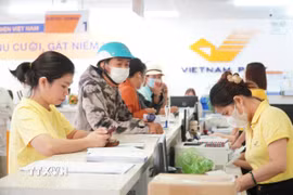 Các địa phương thực hiện thí điểm chuẩn bị các điều kiện nguồn lực cần thiết; phối hợp với Tổng Công ty Bưu điện Việt Nam dự kiến lựa chọn Điểm, danh mục thủ tục hành chính và công việc khác liên quan để đưa Điểm vào hoạt động. (Nguồn: TTXVN)