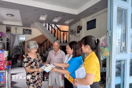Cán bộ, nhân viên Bảo hiểm xã hội thành phố Cần Thơ tuyên truyền, vận động người dân tham gia bảo hiểm xã hội. (Ảnh: TTXVN phát)