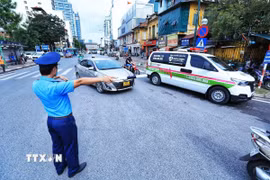 Vượt đèn đỏ để nhường đường cho xe cấp cứu, xe ưu tiên trong trường hợp tình thế cấp thiết sẽ không bị xử phạt vi phạm hành chính. (Ảnh: Tuấn Anh/TTXVN)