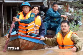 Lực lượng cứu hộ vào thôn Phước Khánh (xã Ninh Phước) để đưa người dân bị mưa lũ cô lập ra ngoài. (Ảnh: Công Thử/TTXVN)