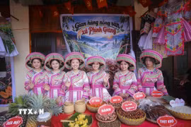 Các thiếu nữ dân tộc Mông giới thiệu nông sản địa phương tại gian hàng xã Phình Giàng, góp phần quảng bá sản vật vùng cao đến du khách. (Ảnh: Xuân Tư/TTXVN)