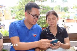 Đoàn viên thanh niên trực tiếp hỗ trợ người dân nâng cao kỹ năng số. (Ảnh minh hoạ: Thùy Dung/TTXVN)