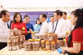 Lãnh đạo tỉnh Đồng Nai tham quan gian hàng đặc sản hạt điều rang muối của địa phương. (Ảnh: Nhật Bình/TTXVN)